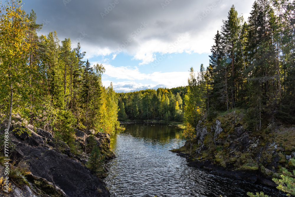 Fototapeta premium Beautiful landscape with waterfall in forest. Kivach waterfall in Karelia, Russia.