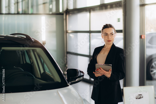 Car dealer woman. Auto dealership and rental concept background.