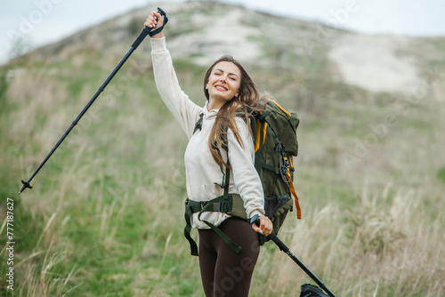 Young woman with backpack hiking in the mountains. Hiking concept. Trekking cliffs. Travel, traveler.