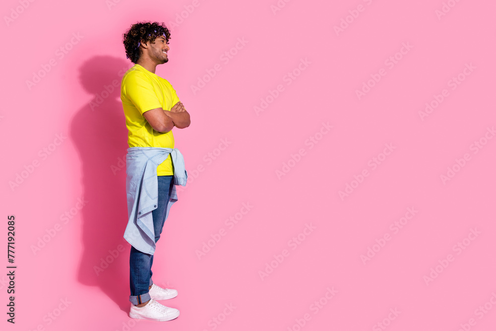 Profile side photo of funny cheerful nice man wear stylish sportswear clothes look empty space isolated on pink color background Profile side photo of funny cheerful nice man wear stylish sportswear clothes look empty space isolated on pink color background