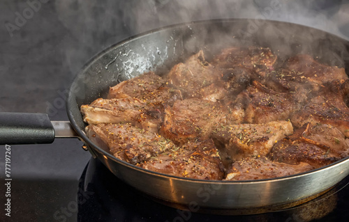 Lamb chops frying on the pan