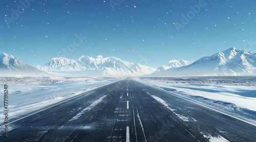A wideangle view of an empty asphalt road leading to the horizon, with snowcovered mountains in the background