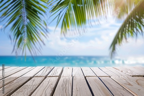 Wooden table top with blurred tropical beach background for product display and summer © K'kriang Krai