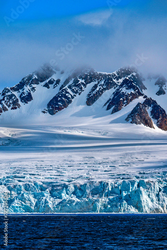 Deep Blue Glacier and Snowcapped Mountains, Albert I Land, Arctic, Spitsbergen, Svalbard, Norway, Europe photo