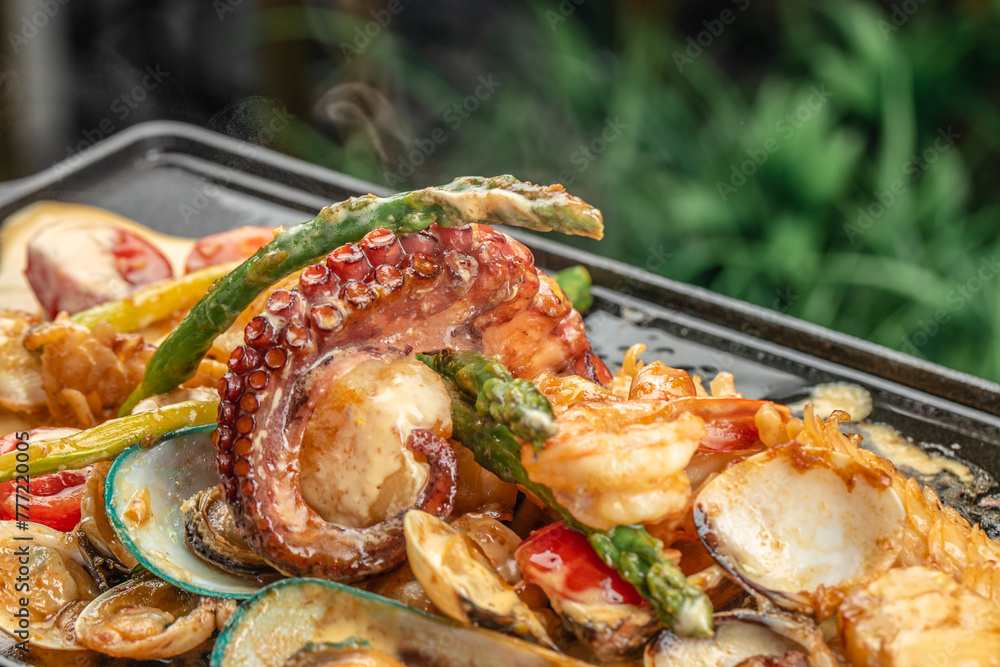 A hot fresh dish with seafood, octopus, mussels, shrimp and asparagus