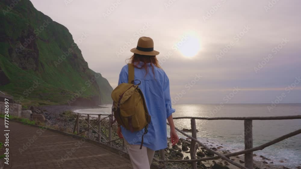 Camera follows woman hiker with backpack. Traveler hiker, enjoys nature and life. Traveling in the mountains, adventure in trip. Lifestyle concept. Woman walking on mountain trail in Madeira Camera follows woman hiker with backpack. Traveler hiker, enjoys nature and life. Traveling in the mountains, adventure in trip. Lifestyle concept. Woman walking on mountain trail in Madeira
