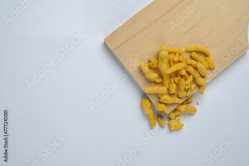 corn chips snack on wooden cutting board isolated on white background.