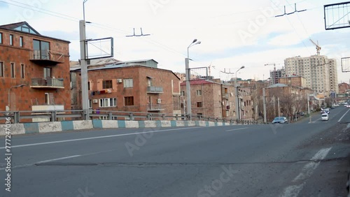 Urban traffic on Lambada bridge overpass in Yerevan, Armenia, against pink tuf stone residential buildings. Cityscape with traffic and architecture, uhd, 4k, 3840, 2160 photo