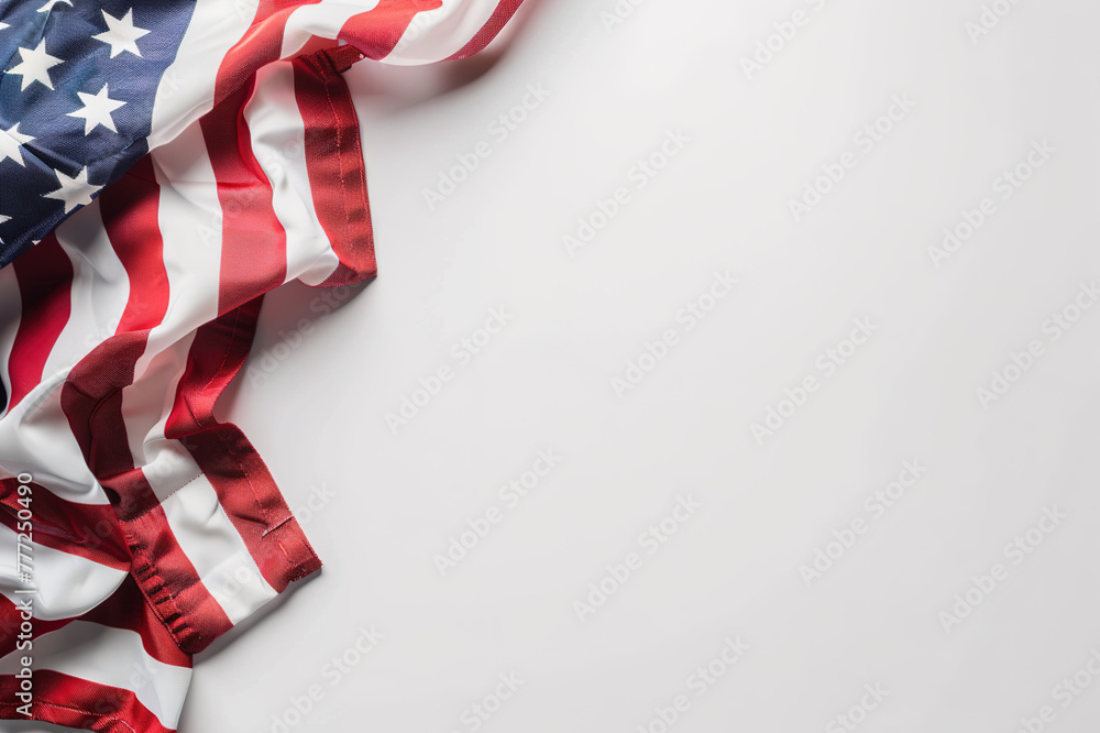 A fragment of the US flag on a white surface with copyspace for text. Background for design. A fragment of the US flag on a white surface with copyspace for text. Background for design.
