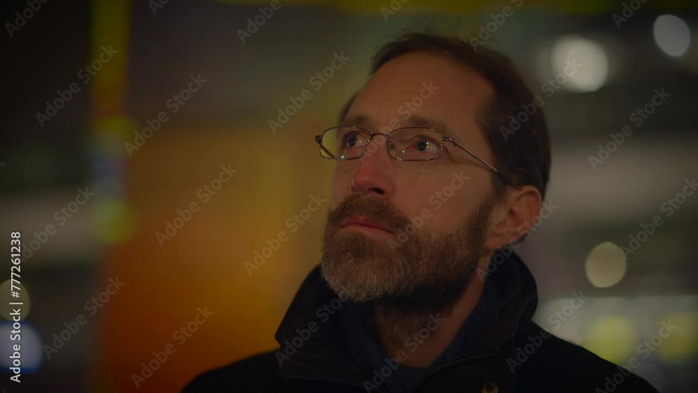 Male Person Thinking and Looking at Colorful Urban Neon Light Outside Male Person Thinking and Looking at Colorful Urban Neon Light Outside
