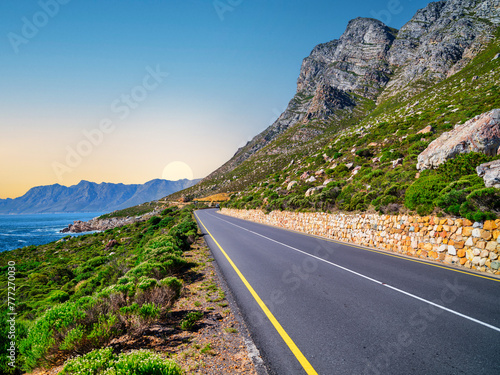 Winding road R44 along indian ocan with lush bush and rugged mountain at Kogel Bay, Cape Town, South Africa photo