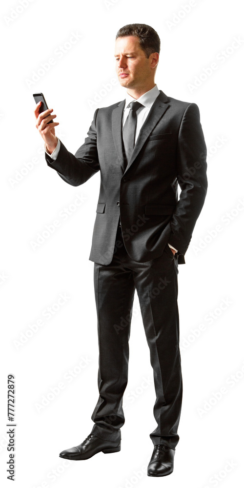 Obraz premium A man in a suit standing and looking at a smartphone on a white background, depicting a business communication concept