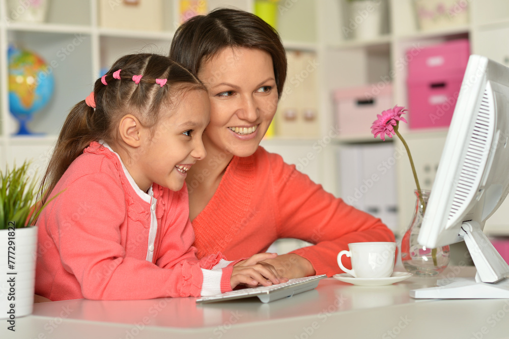 Close up porait of mother and daughter using laptop Close up porait of mother and daughter using laptop