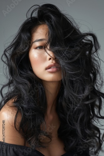 woman with long angular hair blowing out the curls, 