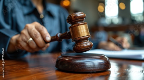 A wooden judges gavel rests on a wooden table