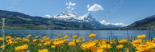 A lake with yellow flowers in the foreground and mountains in the background