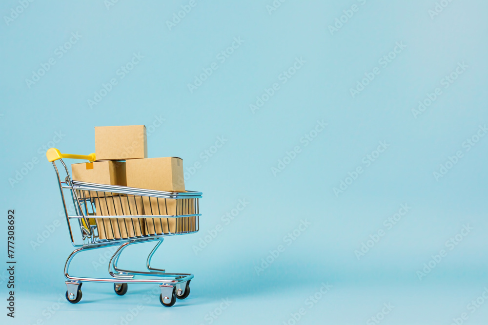 Shopping cart full boxes on blue background