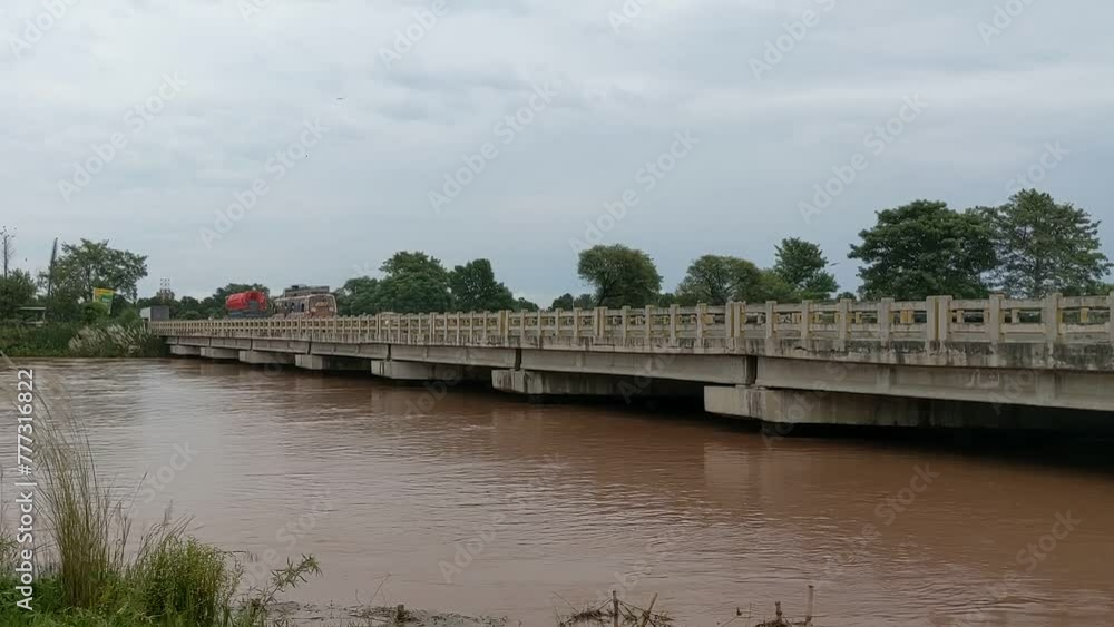 Traffic on a bridge over a river in Pakistan Traffic on a bridge over a river in Pakistan