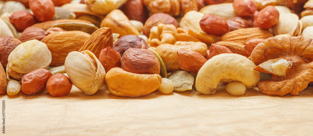 Variety of nuts and seeds closeup with selective focus. Horizontal banner with copy space for text Variety of nuts and seeds closeup with selective focus. Horizontal banner with copy space for text