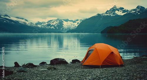 Explore iconic vistas of snow-capped peaks and an orange tent in tranquil waters, shot with Provia film. The Y2K aesthetic and generative AI techniques enhance the atmosphere. photo