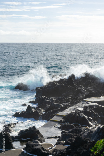 Powerful waves crash along the shoreline of Cinco Ribeiras, a scenic bathing area on Terceira Island, Azores.
