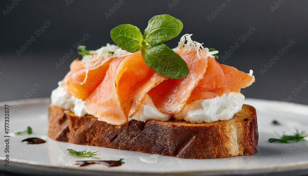 Close-up of toasted bread with smoked salmon and cream cheese. Tasty food. Delicious snack. Close-up of toasted bread with smoked salmon and cream cheese. Tasty food. Delicious snack.