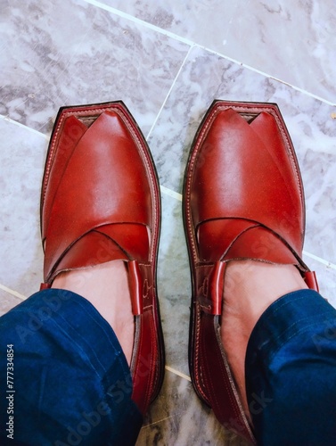 Peshawari chapple kheri Pakistan and Afghanistan's traditional footwear chappal worn on men's feet, leather sandal gent's kherri pashtoon pathani red chapal, charsadda swabi quetta tribal culture  photo