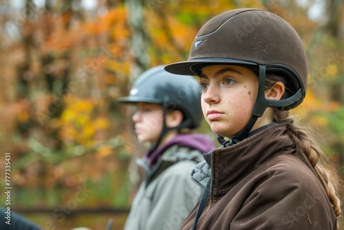 Young Equestrians Wearing Helmets Preparing for Horse Riding in Autumn Scenery, Riders' Training Outdoor © pisan