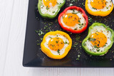 Yellow , red and green pepper with fried eggs