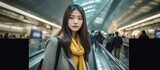 Young asian woman passenger in airport terminal or modern train station.