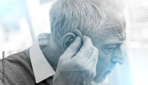 Man putting hearing aids; light effect