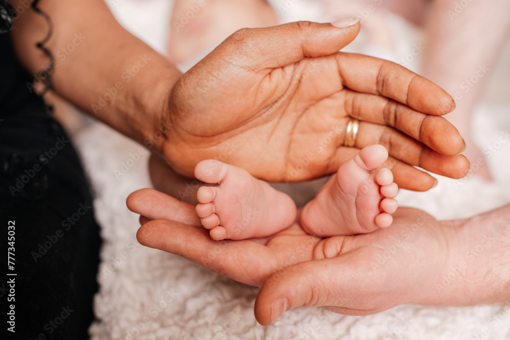 Mothers with newborn baby son, legs and hand Mothers with newborn baby son, legs and hand