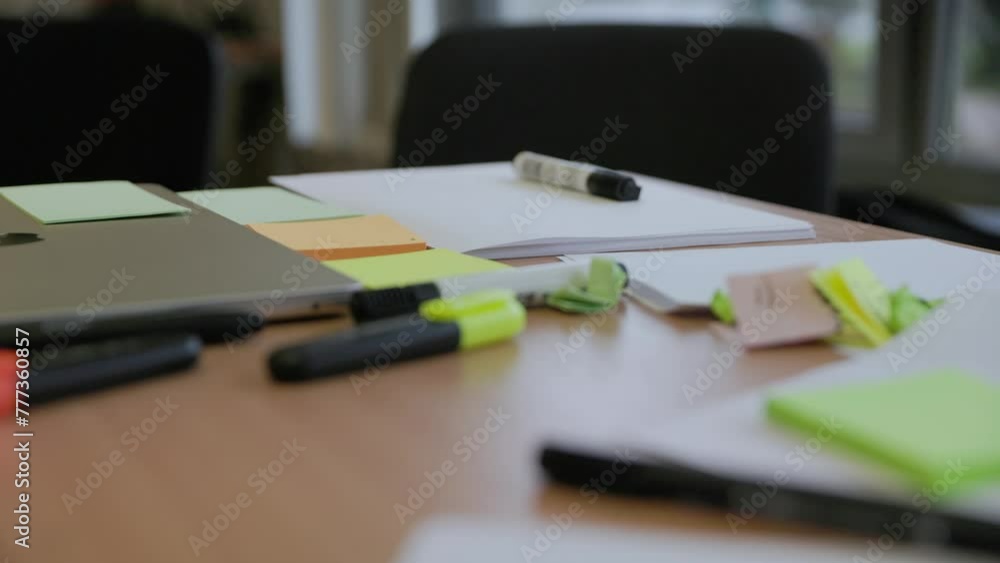 Office school table covered with paper and markers for creative idea generation in slow motion Office school table covered with paper and markers for creative idea generation in slow motion