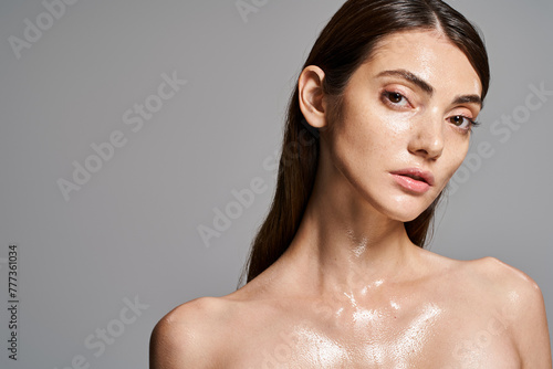 Photography A young Caucasian woman with brunette hair and clean skin covered in water droplets, creating a mesmerizing and refreshing effect