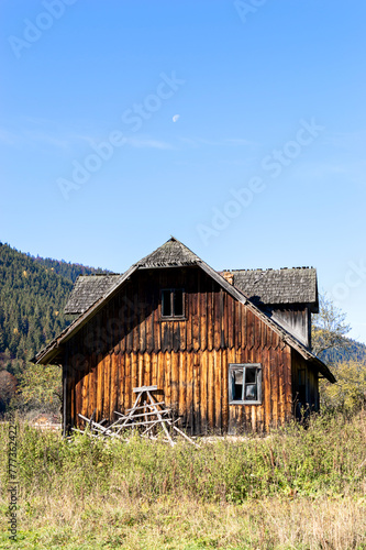 Olden wooden house at the meadow.