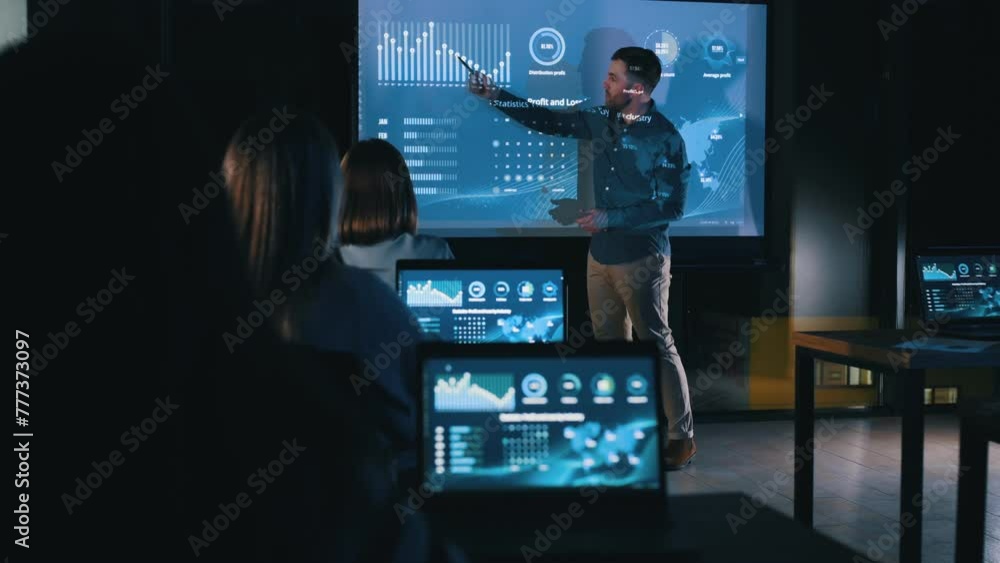 Business coach against projector with data. Business coach against projector with data.