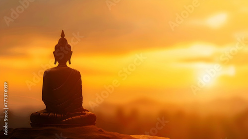 Vesak day banner with copy space, silhouette of buddha against the background of clouds illuminated by the dawn sun with space for text © katerinka