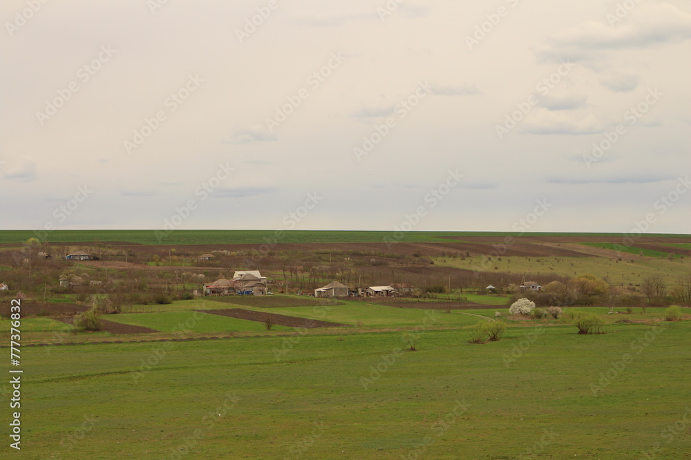 A farm with a house in the distance