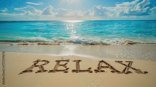 The word RELAX written in the sand on an exotic beach with turquoise water and blue sky, sun shining, summer vacation concept