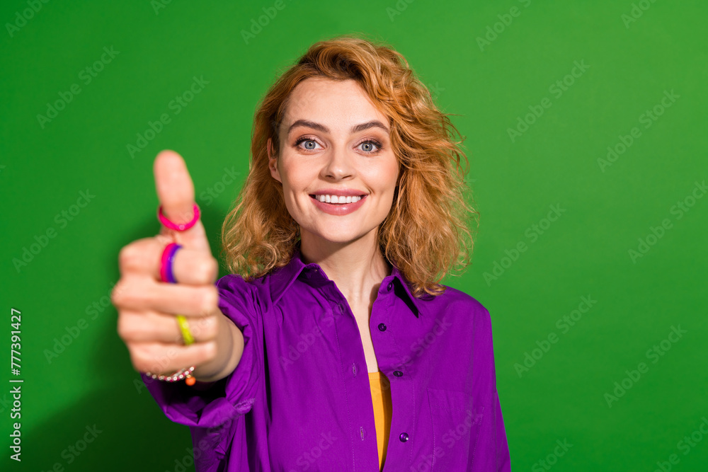 Photo portrait of attractive young girl show thumb up good quality dressed stylish violet garment isolated on green color background Photo portrait of attractive young girl show thumb up good quality dressed stylish violet garment isolated on green color background