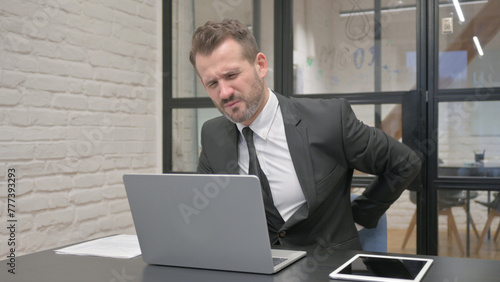Middle Aged Businessman having Back Pain