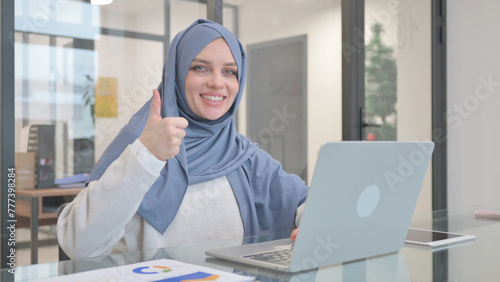 Thumb Up by Woman in Hijab while Working on Laptop