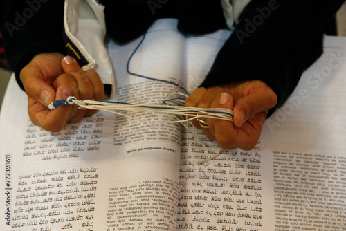 Jewish woman wearing a taleth and reading prayers in a Paris synagogue, France photo