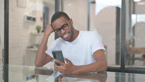 African American Man Celebrating Trade on Phone