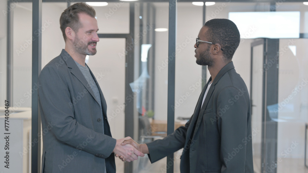 Multi Ethnic People Shaking Hand in Office Multi Ethnic People Shaking Hand in Office