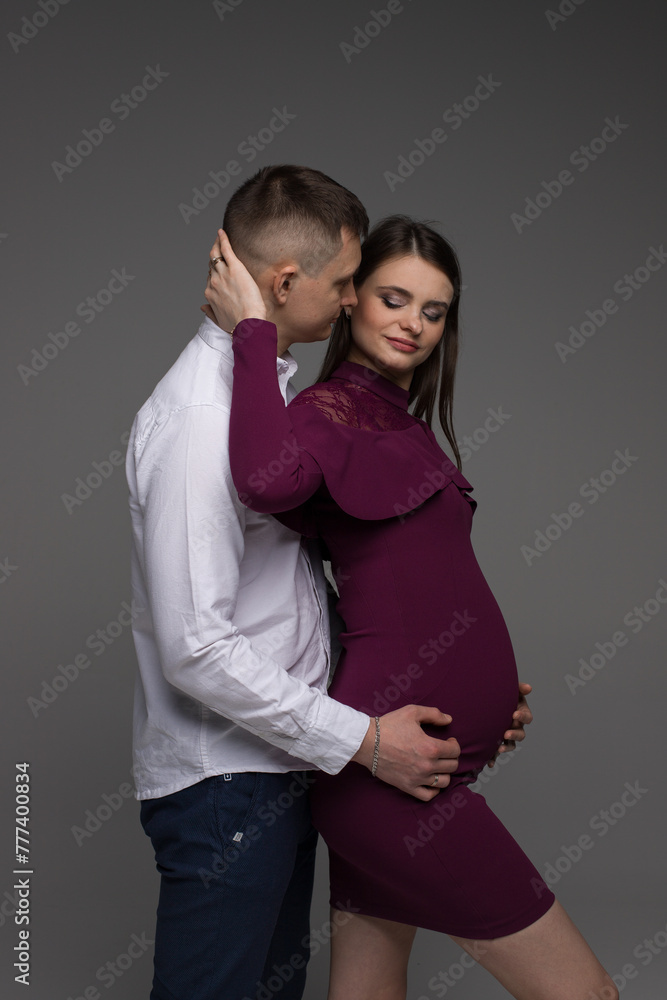 portrait of a couple, pregnant couple, pregnant woman on a grey background, 9 month portrait of a couple, pregnant couple, pregnant woman on a grey background, 9 month