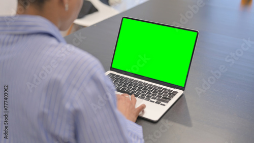 African Woman Working on Laptop with Green Screen