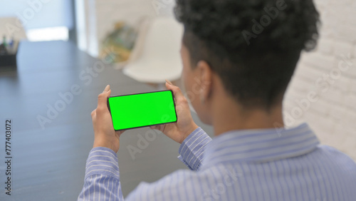 African Woman Holding Horizontal Green Screen Smartphone