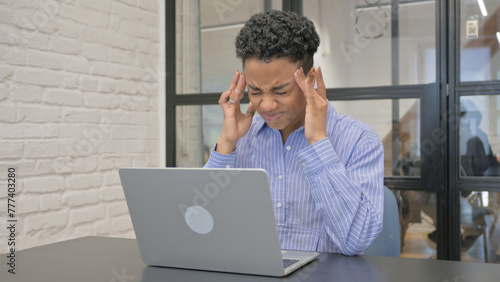 Young African Woman having Headache at Work
