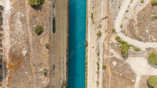 Corinth Canal, Greece. The Corinth Canal is a sluiceless shipping canal in Greece, connecting the Saronic Gulf of the Aegean and the Gulf of Corinth of the Ionian Sea, Aerial View